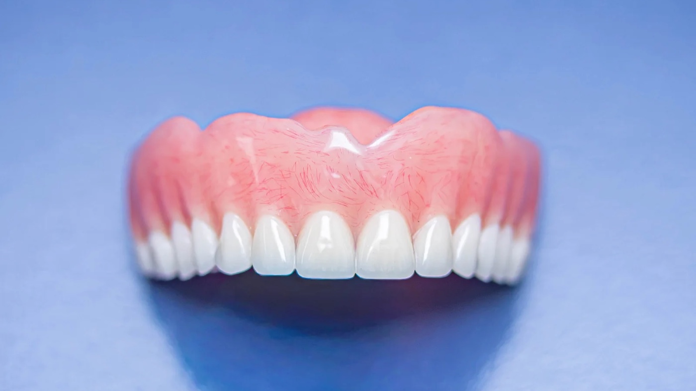 Finished upper complete denture at the IDA laboratory bench